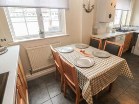 A kitchen with a table and chairs at 16 Forth An Nance in Portreath