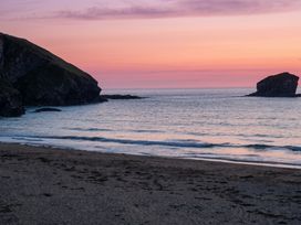 A beach with cliffs and rocks at sunset at 16 Forth An Nance in Portreath
