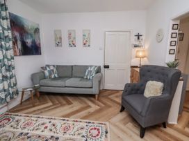 A living room with a sofa and armchair at 55 Meldon terrace Newbiggin-by-the-Sea