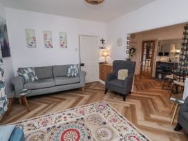 A living room with a sofa and armchair at 55 Meldon terrace Newbiggin-by-the-Sea