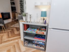 A living room with a bookshelf displaying board games at 55 Meldon terrace Newbiggin-by-the-Sea