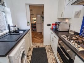 A kitchen with a sink and gas stove at 55 Meldon terrace in Newbiggin-by-the-Sea