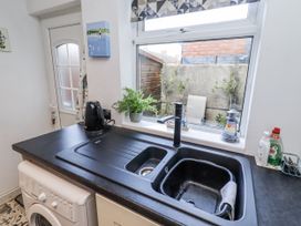 A kitchen with sink and kettle at 55 Meldon terrace in Newbiggin-by-the-Sea