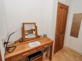 A bedroom with a desk and mirror at 55 Meldon terrace in Newbiggin-by-the-Sea