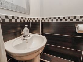 A bathroom with a sink and wall tiles at 55 Meldon terrace in Newbiggin-by-the-Sea