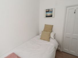 A bedroom with a bed and pillows at 55 Meldon terrace in Newbiggin-by-the-Sea