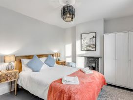 A bedroom with a bed and bedside tables at Bay Tree Cottage in Heacham