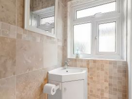 A bathroom with a sink and toilet at Bay Tree Cottage in Heacham