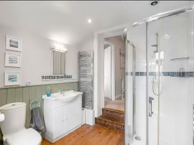 A bathroom with a sink, toilet, and shower at Bay Tree Cottage in Heacham