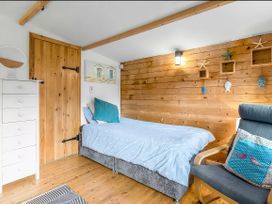 A bedroom with a bed and drawers at Bay Tree Cottage in Heacham