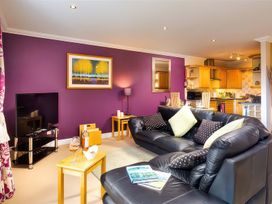 A living room with a sofa and television at The Gallery in Windermere