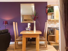 A dining room with a table and chairs at The Gallery in Windermere
