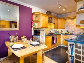 A kitchen with a dining table and stove at The Gallery in Windermere
