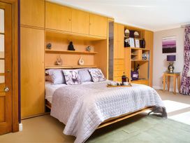 A bedroom with a bed and shelves at The Gallery in Windermere