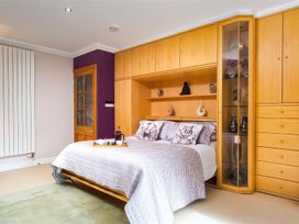 A bedroom with a bed and cabinet at The Gallery in Windermere