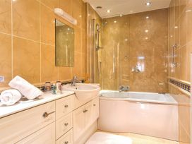 A bathroom with a bath tub and sink at The Gallery in Windermere