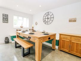 A dining room with a table and benches at The Ivy in Norwich