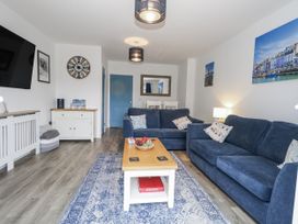 A living room with a sofa and coffee table at 8 Park View Grove in Weymouth