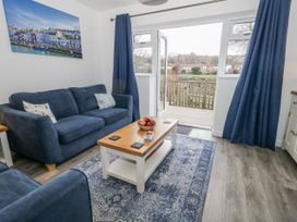 A living room with a sofa and coffee table at 8 Park View Grove in Weymouth