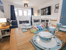 A dining room with a table set up at 8 Park View Grove in Weymouth