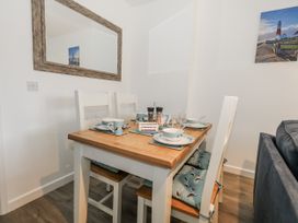 A dining room with a table and chairs at 8 Park View Grove Weymouth