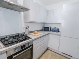 A kitchen with a gas stove, oven, and microwave at 8 Park View Grove, Weymouth