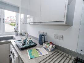 A kitchen with a sink and kettle at 8 Park View Grove in Weymouth