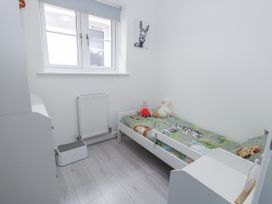 A bedroom with a bed and toys at 8 Park View Grove in Weymouth