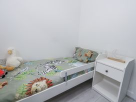 A bedroom with a bed and bedside table at 8 Park View Grove in Weymouth