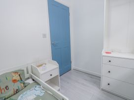 A bedroom with a bed and drawer unit at 8 Park View Grove in Weymouth