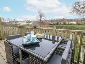 An outdoor seating area with table and chairs at 8 Park View Grove Weymouth