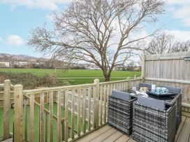 An outdoor area with a table and chairs at 8 Park View Grove in Weymouth