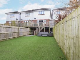 A garden with a decked area and sofa at 8 Park View Grove Weymouth