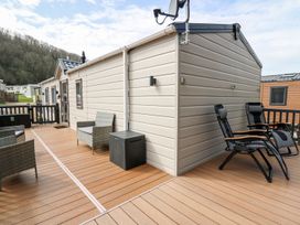 An outside area with seating and a satellite dish at 33 Woodpecker Lodge, Llanarth