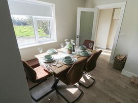 A dining room with a table set for a meal at Doire Fhatharta Beag, Carraroe, County Galway