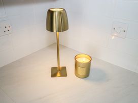 A kitchen with a lamp and a candle at Doire Fhatharta Beag, Carraroe, County Galway