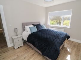 A bedroom with a bed and nightstand at Doire Fhatharta Beag Carraroe, County Galway