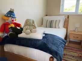A bedroom with a single bed and stuffed toys at Seadrift Bush Estate near Happisburgh