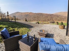 An outdoor area with chairs and a fire pit at Bluebelle - Crossgate Luxury Glamping Hartsop