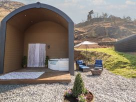 An outdoor seating area with a hot tub at Bluebelle - Crossgate Luxury Glamping Hartsop