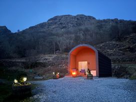An outdoor cabin with seating and a fire pit at Bluebelle - Crossgate Luxury Glamping in Hartsop