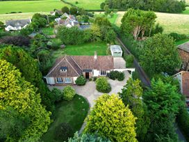 An aerial view of a house with a garden and driveway at Barton Lodge in Porlock