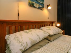 A bedroom with a bed and bedside lamps at Barton Lodge in Porlock
