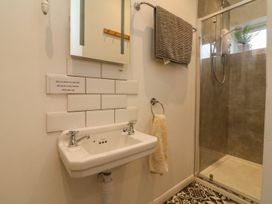 A bathroom with a sink and shower at Barton Lodge in Porlock