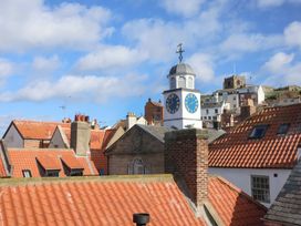 A view of rooftops and a clock tower at The Four Views in Whitby