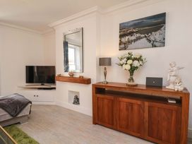 A living room with a television and console table at The Four Views in Whitby