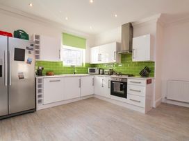 A kitchen with a refrigerator and oven at The Four Views in Whitby