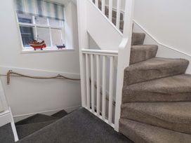 A staircase with a window and decorative boats at The Four Views in Whitby