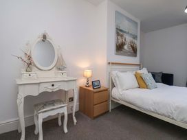 A bedroom with a bed and a mirror at The Four Views in Whitby