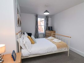 A bedroom with a bed and dresser at The Four Views in Whitby